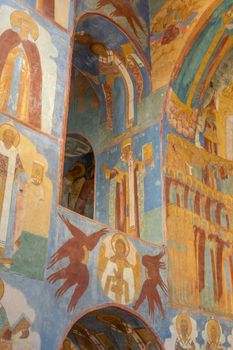 Intricate church frescoes depicting religious icons and angels captured in detail.