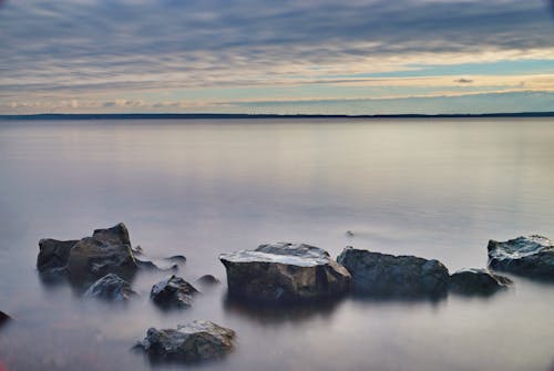 Free Rock Boulder Above the Foggy Sea Water Surface Stock Photo