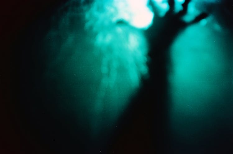 Photo Of Person's Hand Reaching Out Underwater