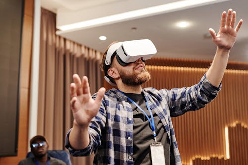 Free Man Wearing Virtual Reality Headset Raising His Hands Stock Photo