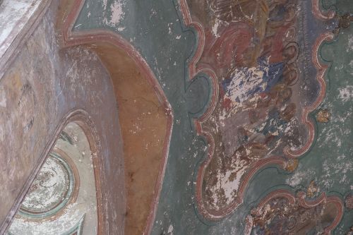 Free Close-up of a weathered fresco on an orthodox church ceiling, showing paint decay and historical art. Stock Photo