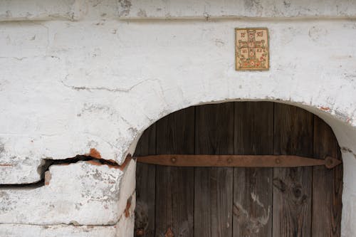 Arched Concrete Wall with Wooden Door