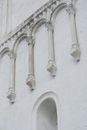Detailed view of an ancient stone castle facade featuring medieval architectural elements.