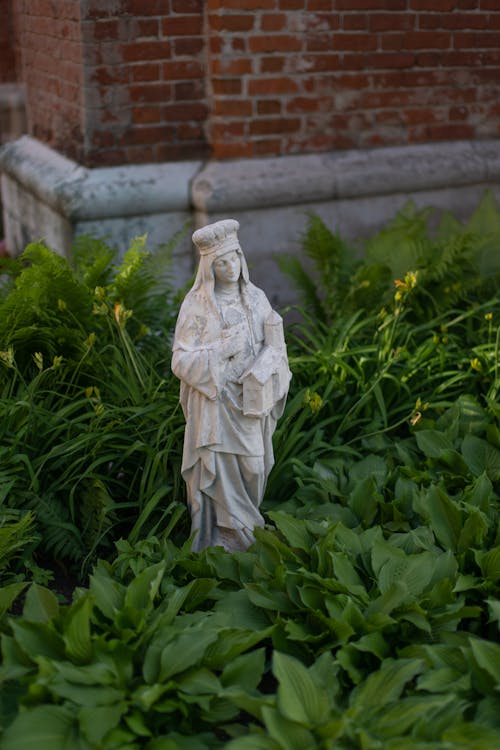 Sculpture of Virgin Mary surrounded by Plants 