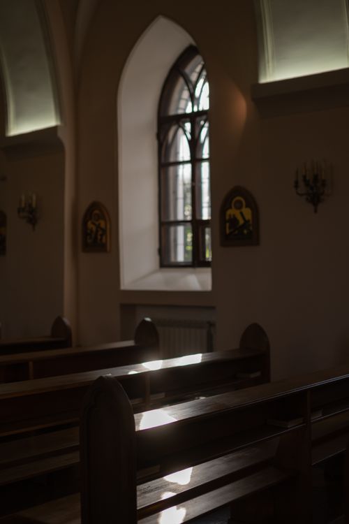 Free Sunlight streams through a gothic window, illuminating the tranquil church interior. Stock Photo
