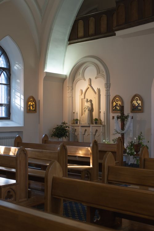 Free Peaceful church interior showcasing an altar and wooden benches, ideal for religious themes. Stock Photo