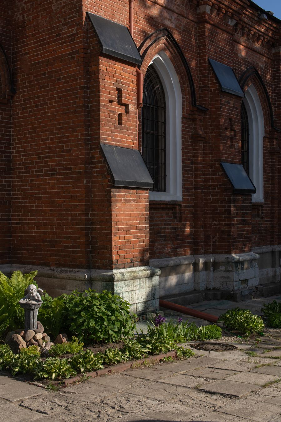 Stock photo of a brick church building surrounded by greenery