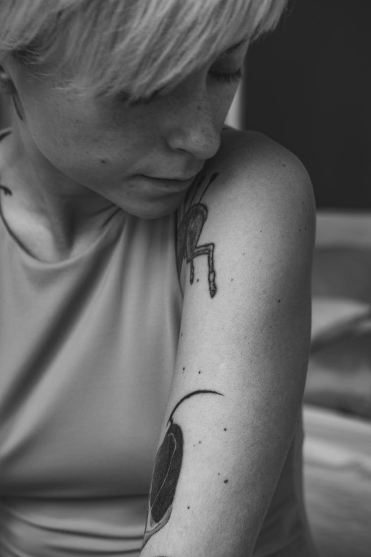 Woman With Tattoo On Left Arm