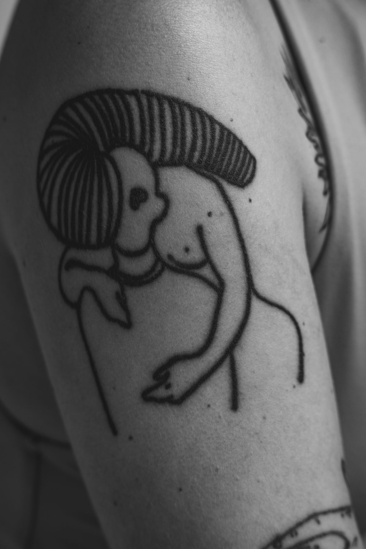 Minimalist linework tattoo of an embrace
