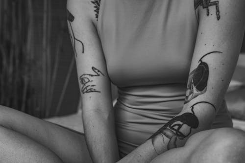 Grayscale Photo of Woman With Tattoo on Her Right Arm