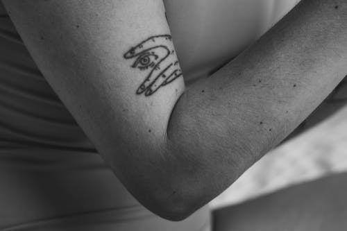 Grayscale Photo of Tattoo on Arm