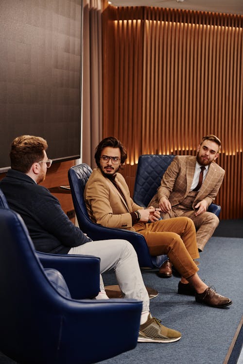 Businessmen Sitting on Leather Office Armchairs