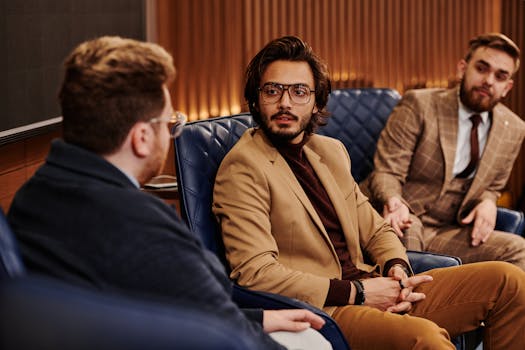 Three businessmen discussing strategy in a modern office setting, emphasizing teamwork and diversity.