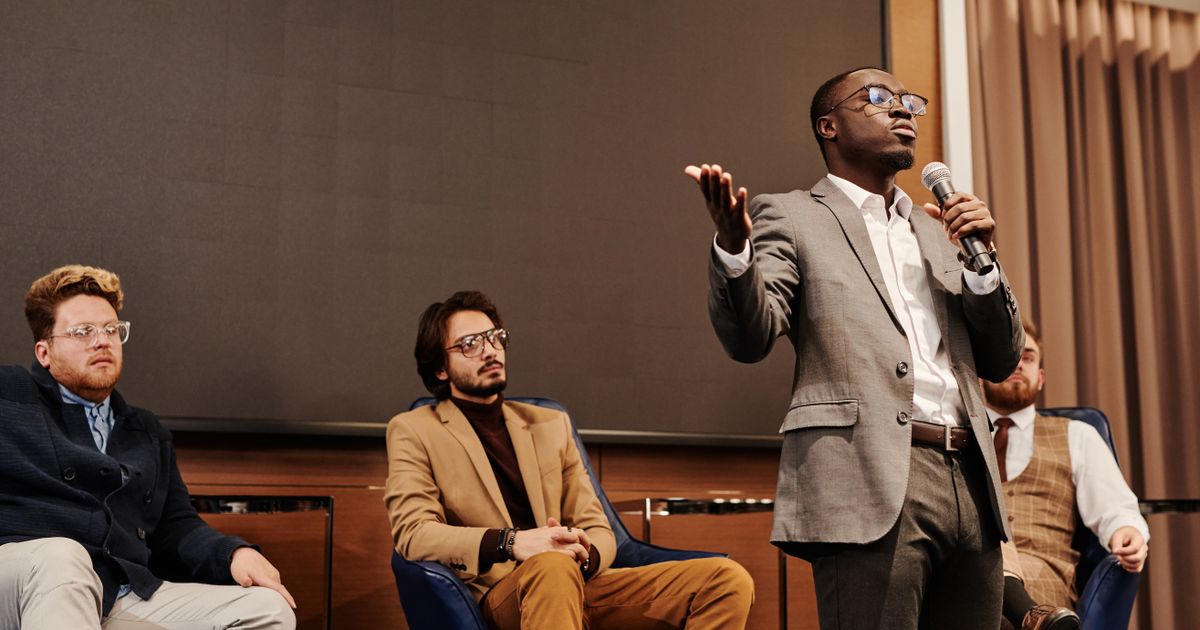 Sustainable fashion professionals in a panel discussion at a UK industry conference.