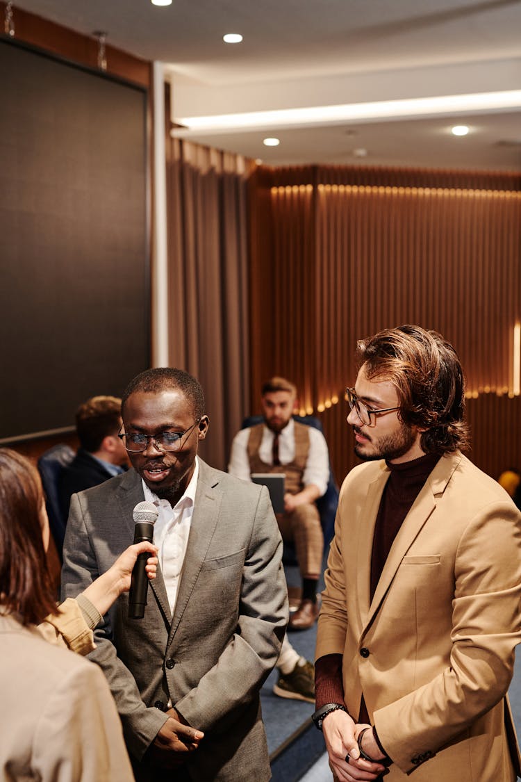 A Man In Corporate Attire Talking In An Interview