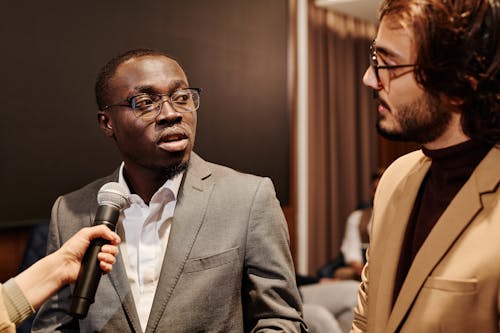 A Man in Corporate Attire Talking at an Interview