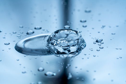 Captivating close-up of a water droplet creating a splash on a reflective surface.