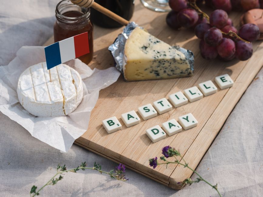 Assortment of French cheeses with a glass of red wine