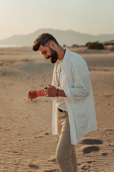 A man happily walking on a sandy desert at sunset, radiating joy.