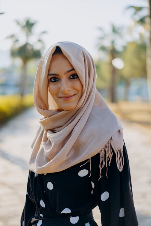 A Woman In Polka Dots Dress Wearing a Hijab