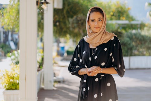 Free A Beautiful Woman in Polka Dot Dress and Hijab Stock Photo