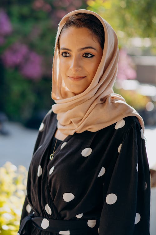 Woman in Black Polka Dot Dress With Hijab