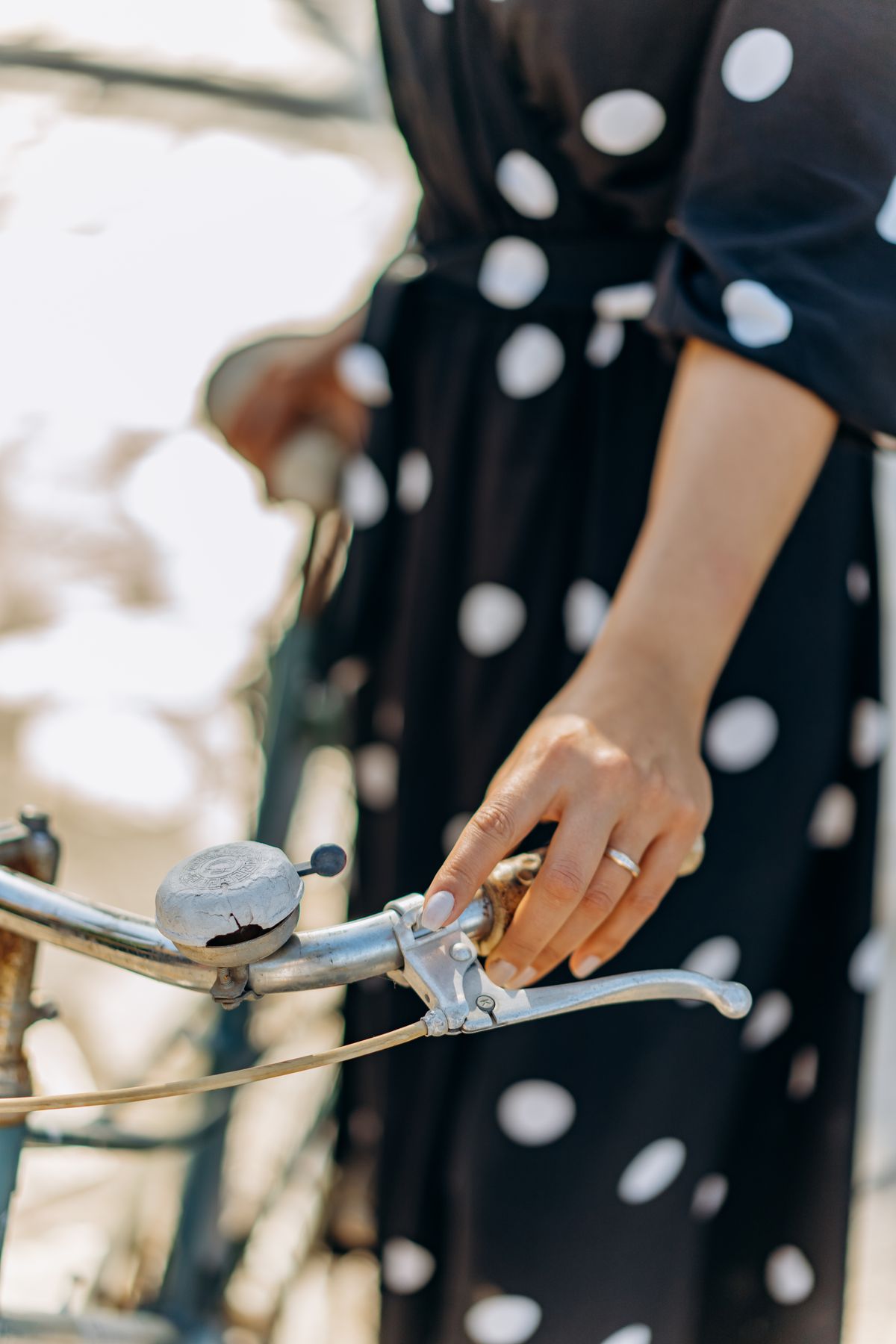 A bell on a bicycle handlebar — the European summer spirit of the polka dot