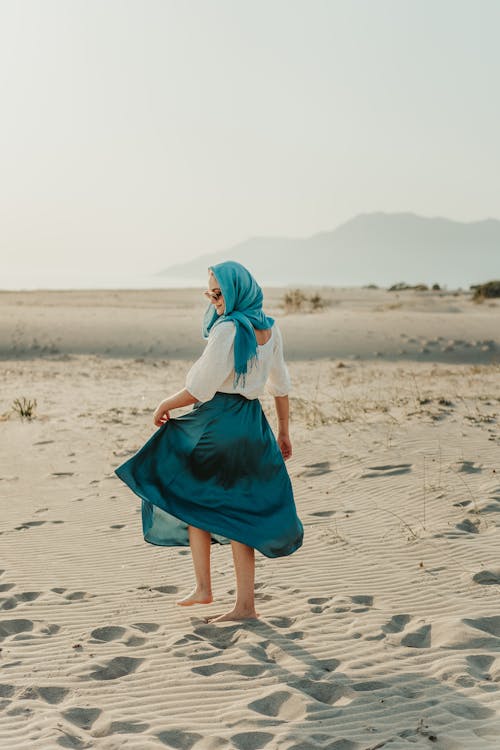 A Casual Woman Walking in the Sand