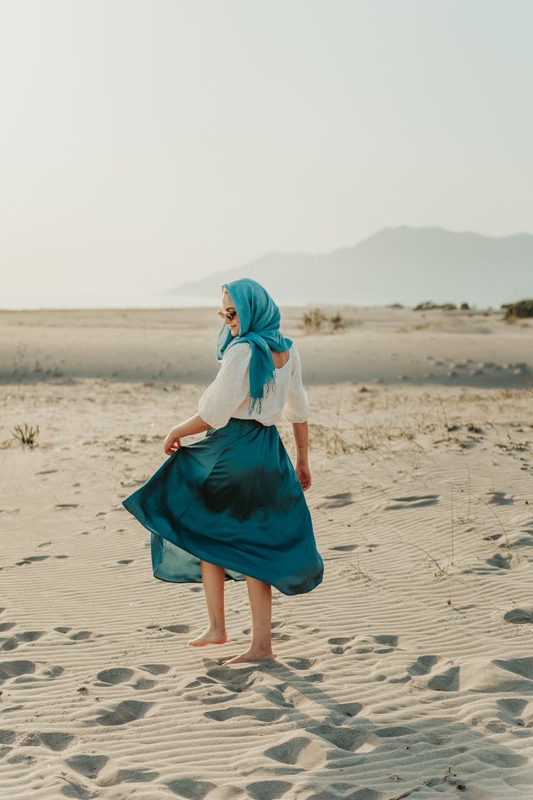 A Casual Woman Walking In The Sand