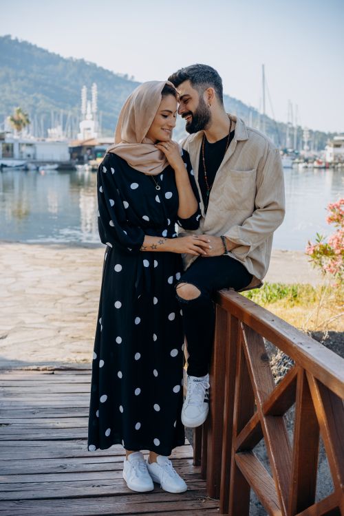 Free A joyful couple enjoying a moment by the waterfront, showcasing love and connection. Stock Photo