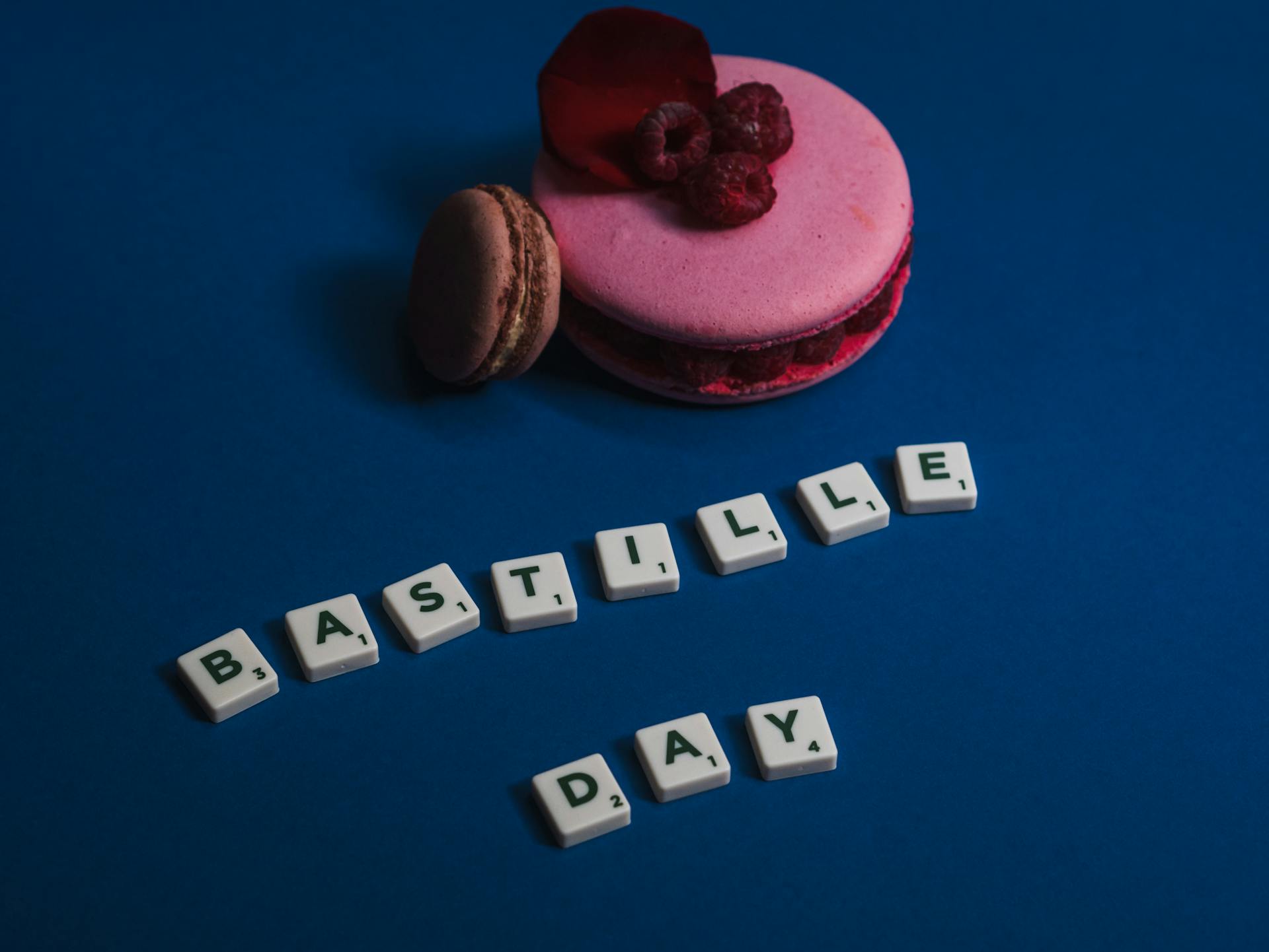 Celebrate Bastille Day with delicious French macarons on a vibrant blue background.