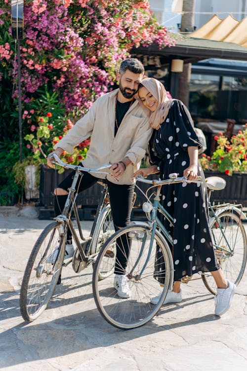 A Lovely Couple Riding on Bicycles