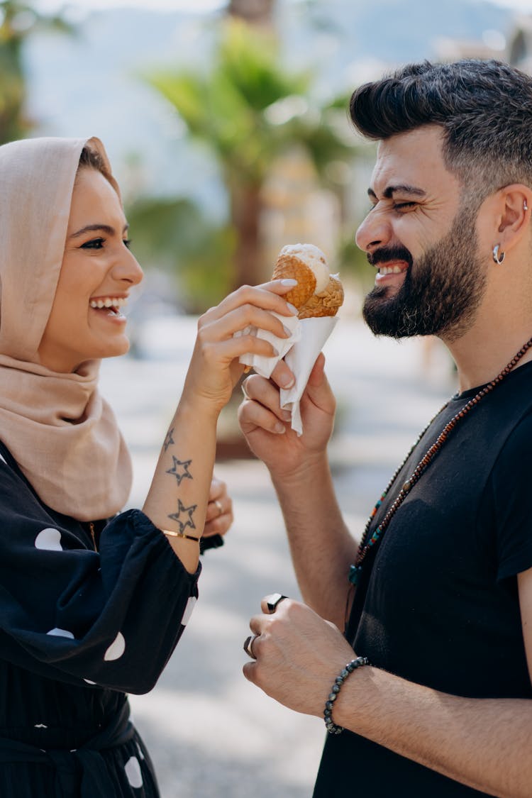 Couple Holding Ice Cream On Cones