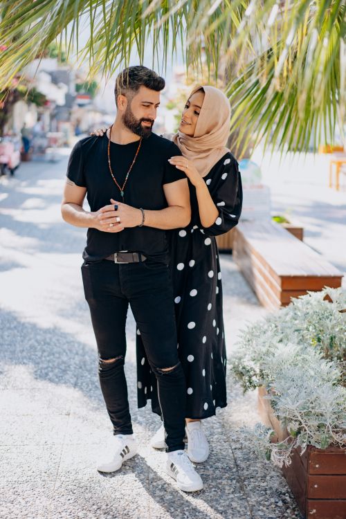 Free A stylish couple enjoying a sunny day outdoors, showcasing love and fashion. Stock Photo