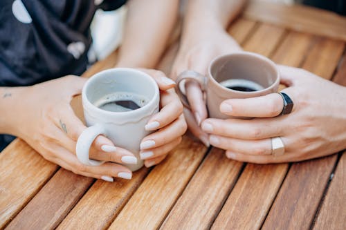 High Angle View of Two People Drinking Cups of Coffee
