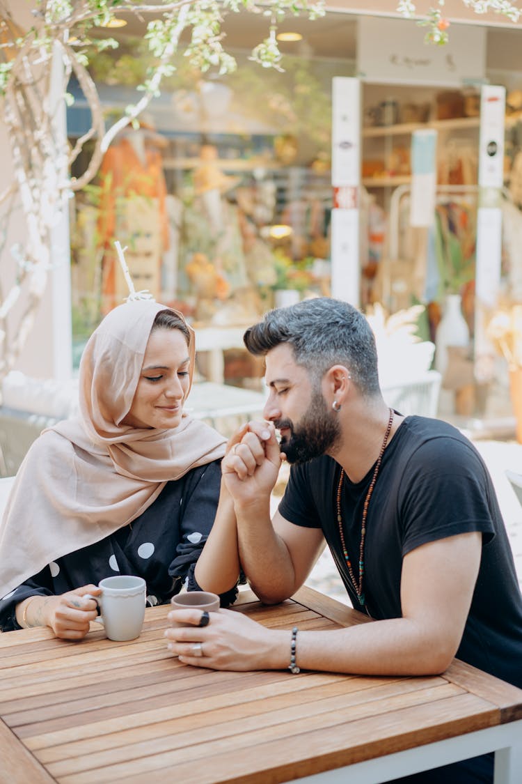 Bearded Man Kissing The Hand Of A Woman