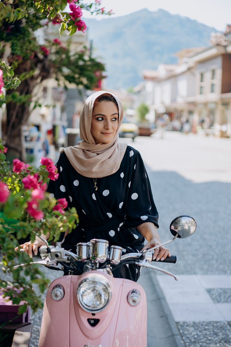 Woman Riding On A Pink Scooter