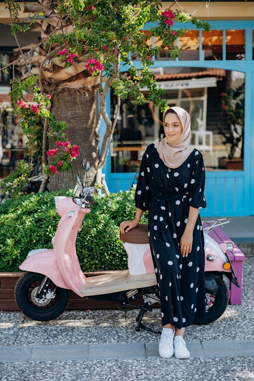 Free Woman Posing with Motorcycle at the Back Stock Photo