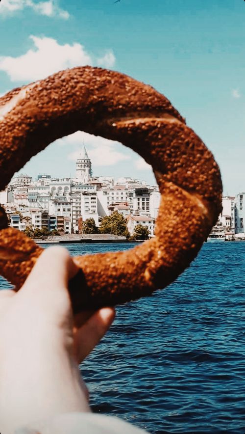 Free A picturesque view of Galata Tower framed through a simit held over the Bosphorus in Istanbul, Turkey. Stock Photo