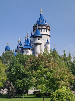 Stunning fairy tale castle with blue domes in a lush Eskişehir park setting.