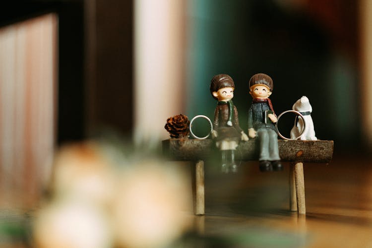 Small Figurines And A Pair Of Wedding Rings