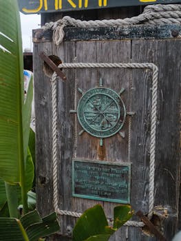Weathered wooden sign with nautical theme in Newport Beach, California.