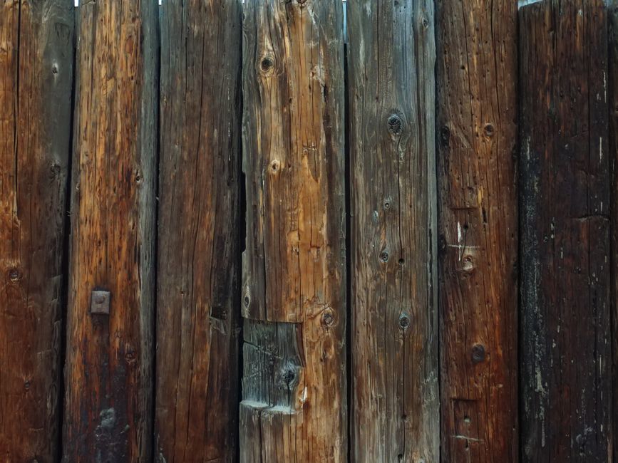 Detailed view of a rustic wooden fence showcasing weathered textures and natural grains.