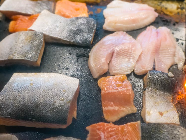 A Selection Of Fresh Fish Fillets On A Griddle