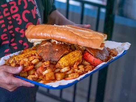 A vibrant platter of fresh seafood including shrimp and crab with grilled corn and bread.