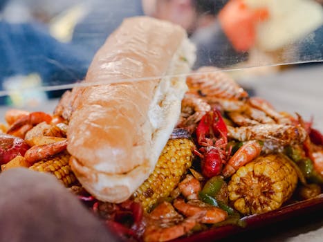 Close-up of a savory seafood boil with shrimp, crab, corn, and bread. Perfect for food lovers.