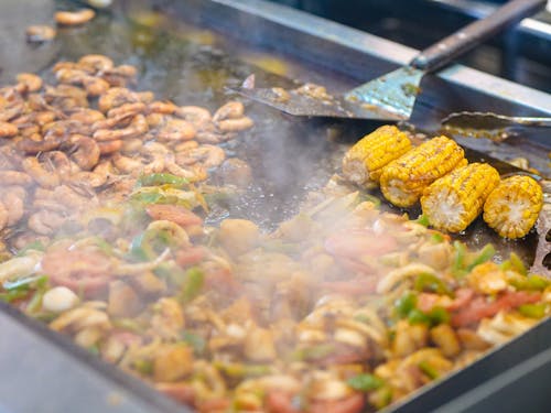 Seafood and Corn Frying on Stainless Surface