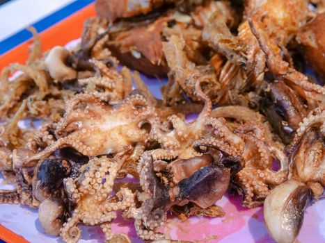 Close-up of delicious crispy fried octopus served as street food, highlighting its tentacle detail.