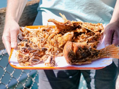 A tray of grilled seafood including fish and octopus, perfect for a summer meal.