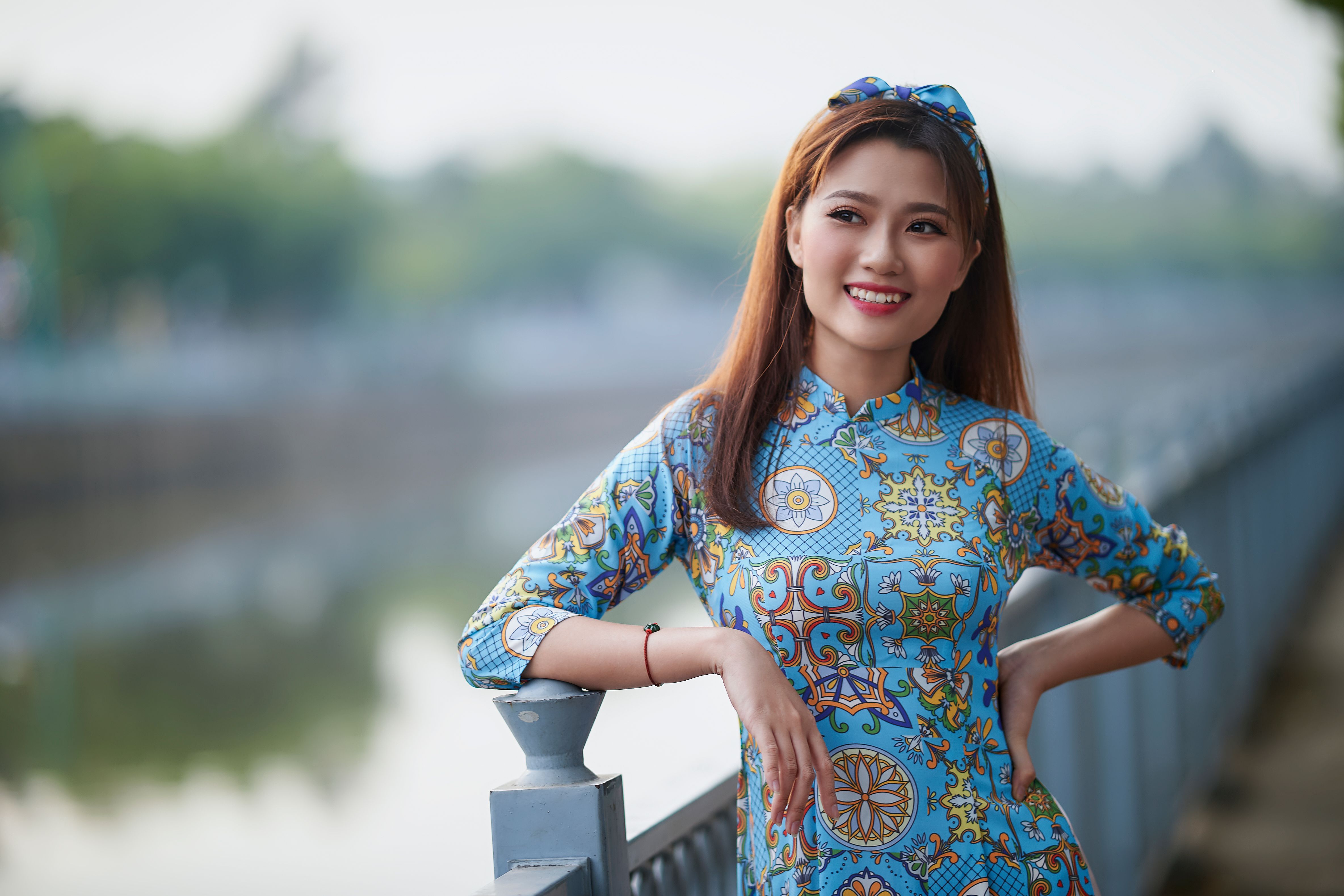 Woman Wearing Blue Dress Leaning on a Railing · Free Stock Photo